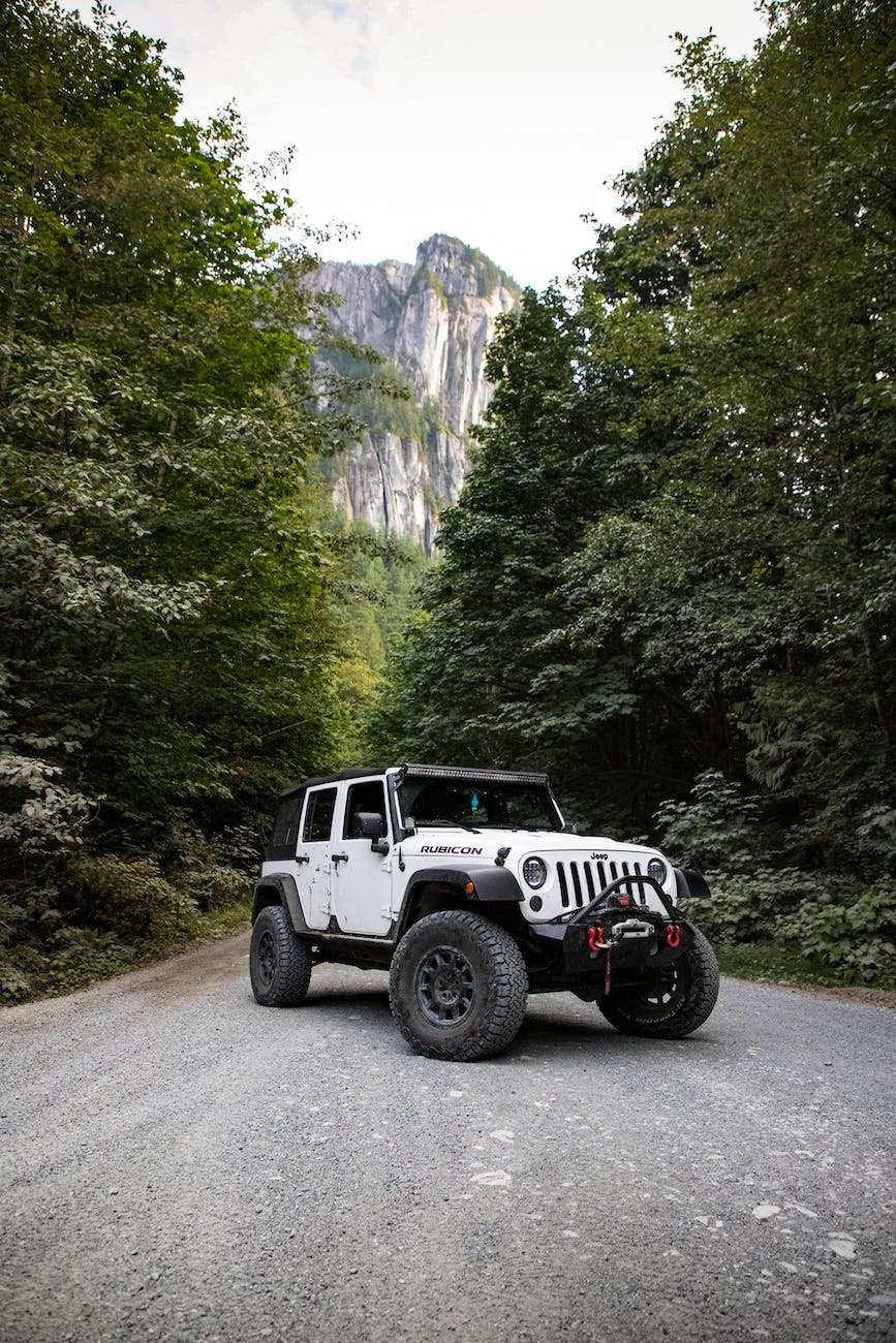 white jeep wrangler on asphalt road