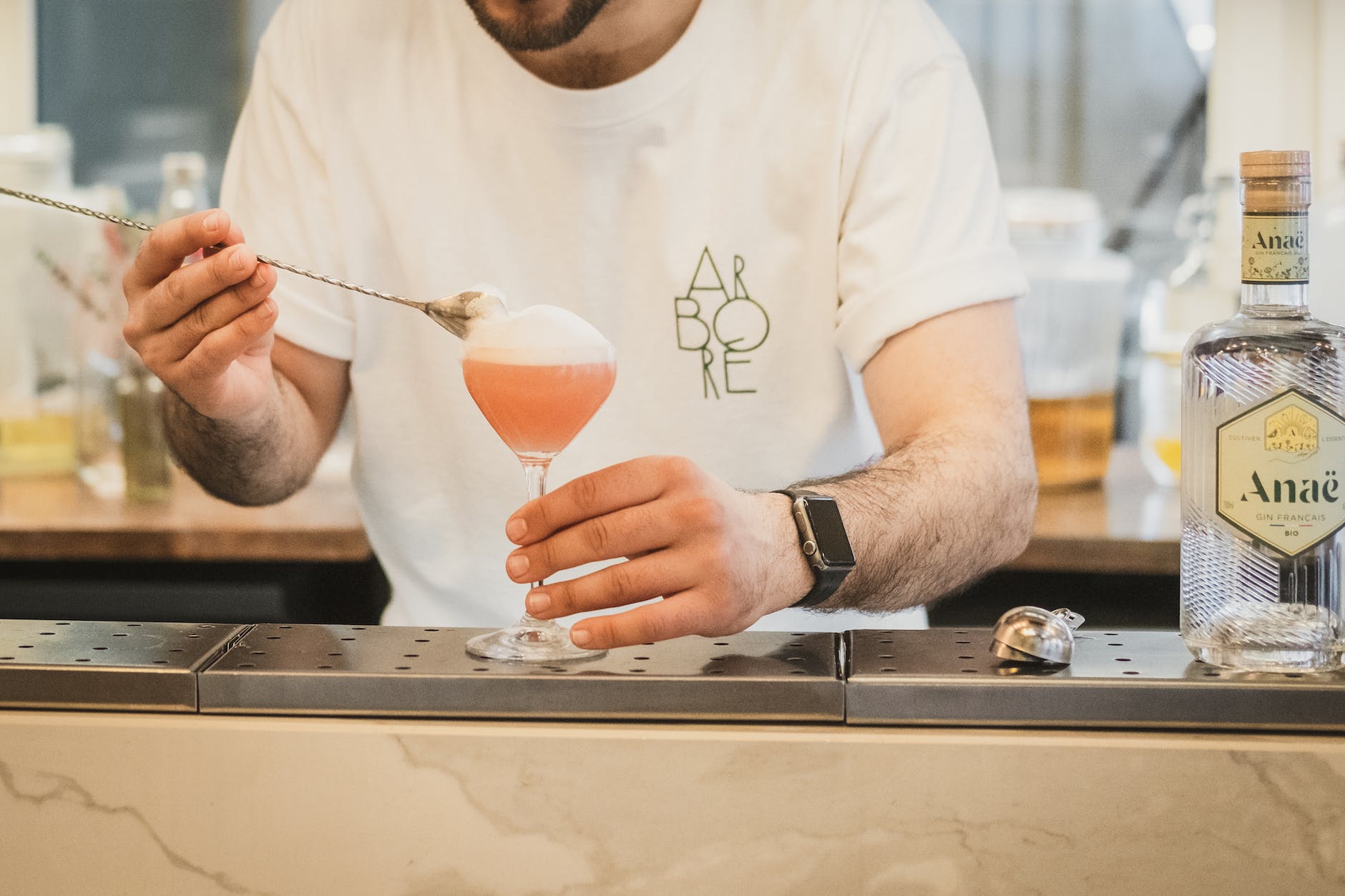 photo of a bartender preparing a cocktail with gin