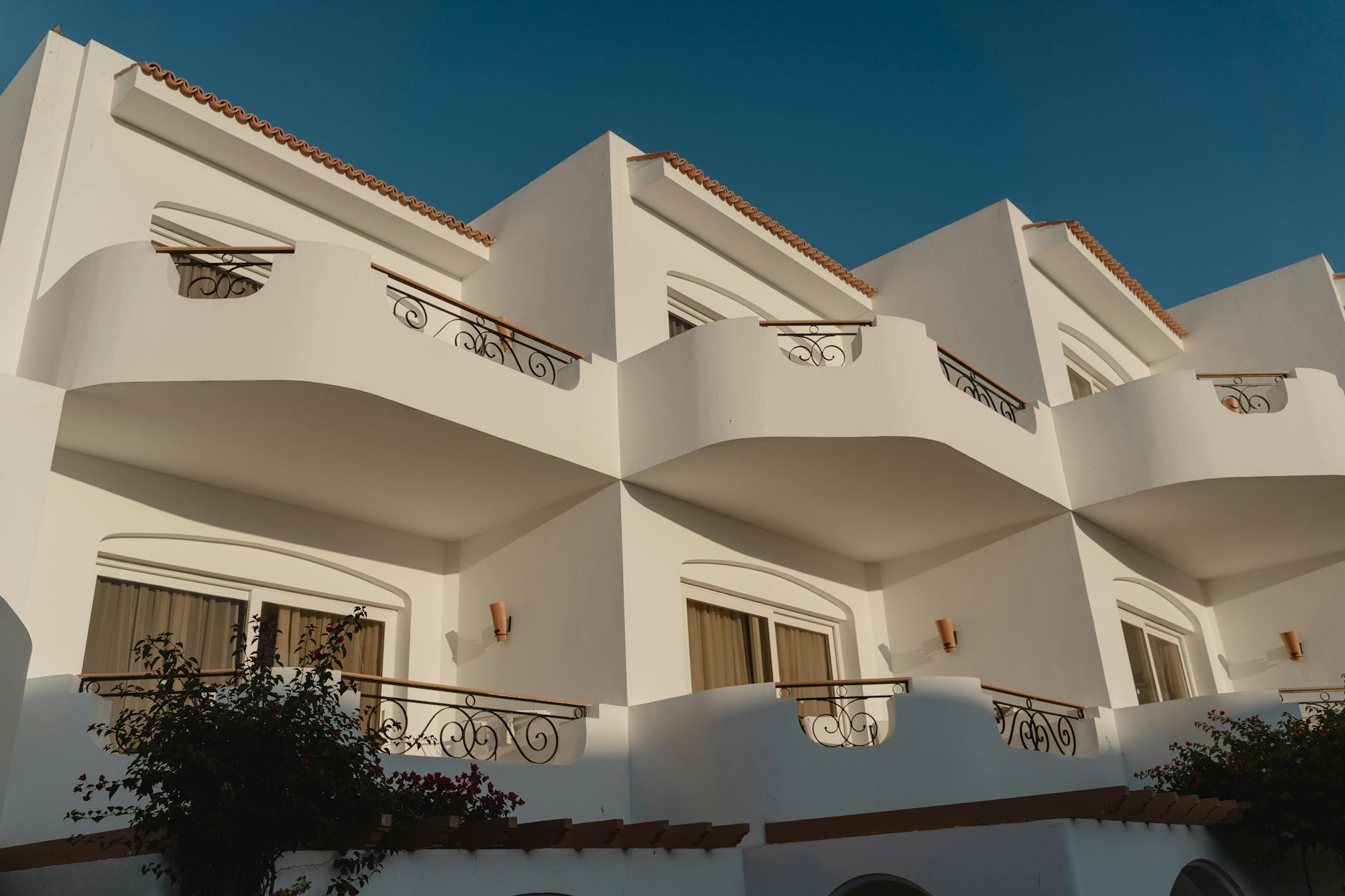 facade of a white luxurious hotel with balconies