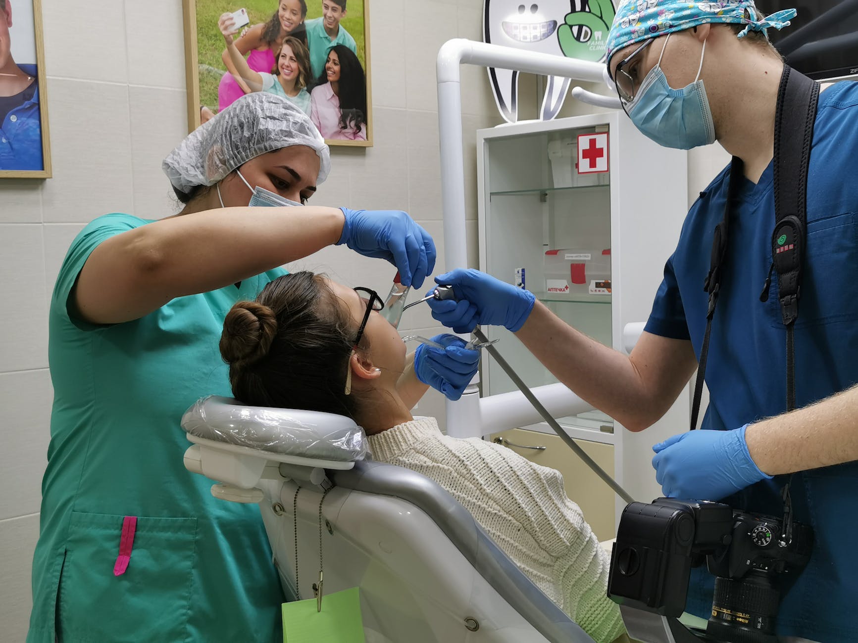 a dentist and a nurse treating a patient